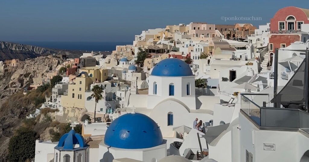 青いドームと白い街並みが連なるサントリーニ・イア。エーゲ海を見下ろす絶景。